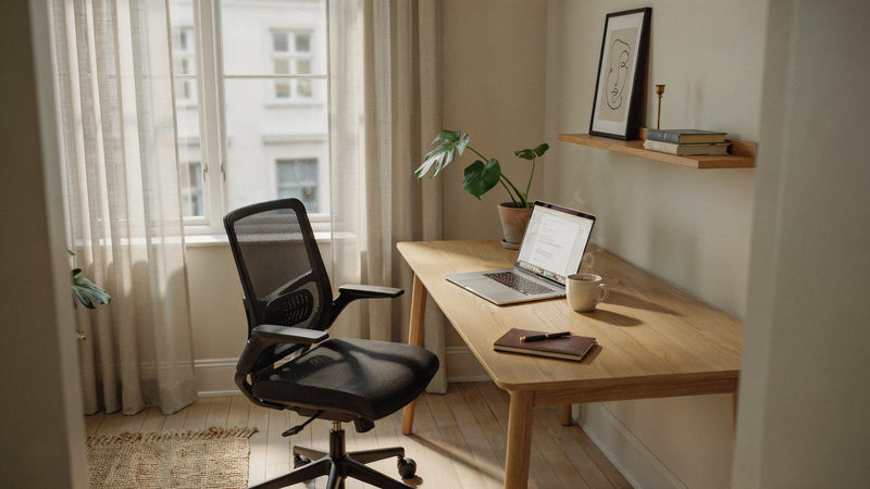 Stylish modern home office with ergonomic mesh chair and natural light